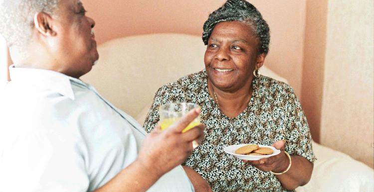 elderly man and woman having a cup of tea