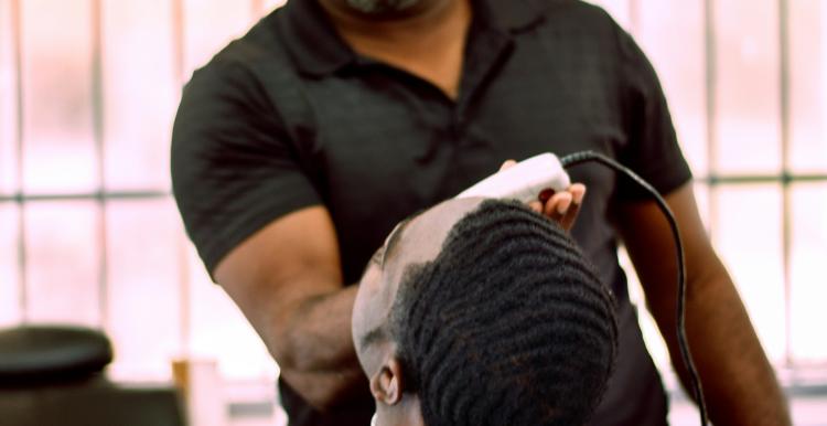 Barber giving a haircut to a person