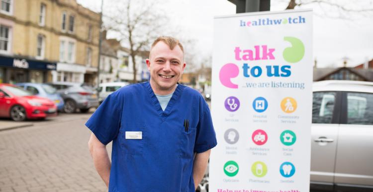 SEL CCG nurse in scrubs in front of healthwatch banner