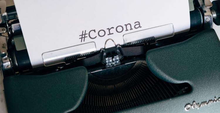 typewriter with corona on page
