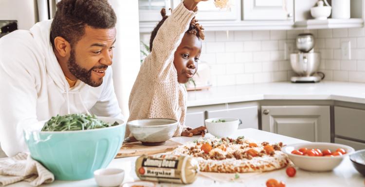 Dad with son playing in kitchen