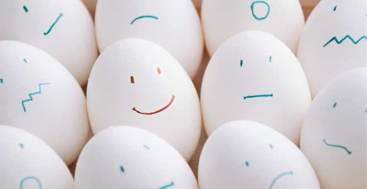 eggs with different expressions drawn up lined up