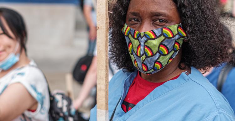  black female nurse with facemask at public demonstration.jpg