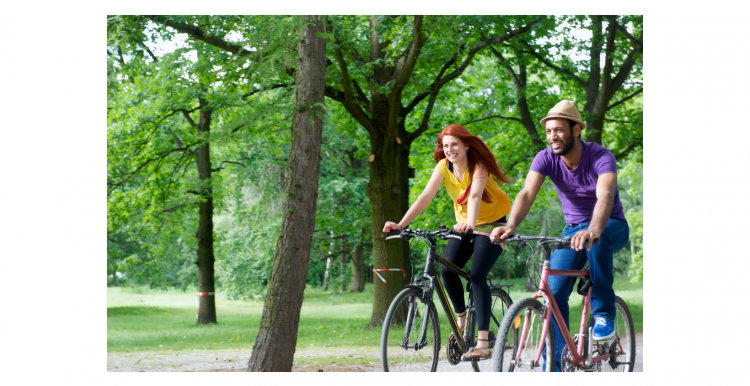 2 people riding bikes in a park 2 people riding bikes in a park