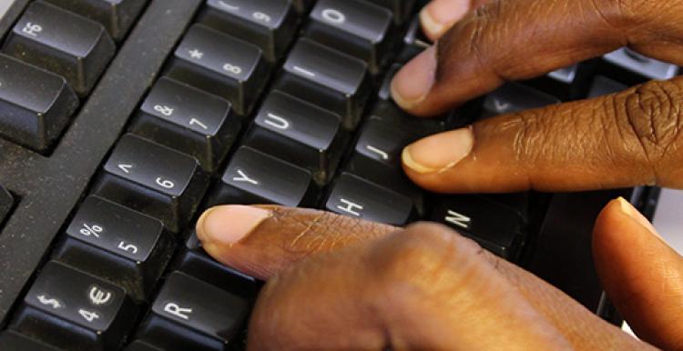 Hands typing on keyboard