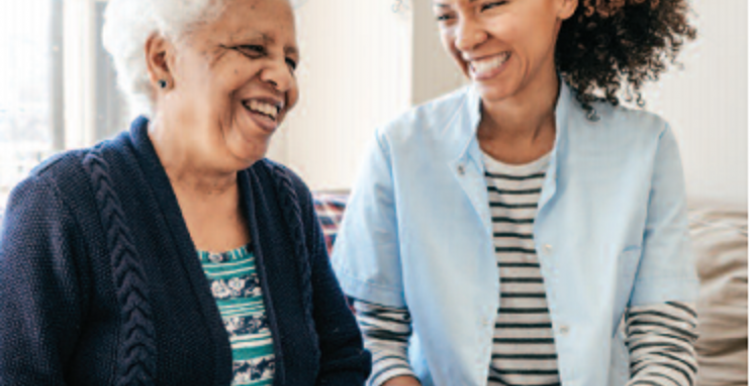 Two women laughing with one another