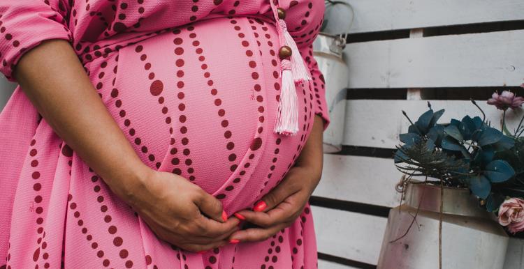 Woman holding her pregnant belly