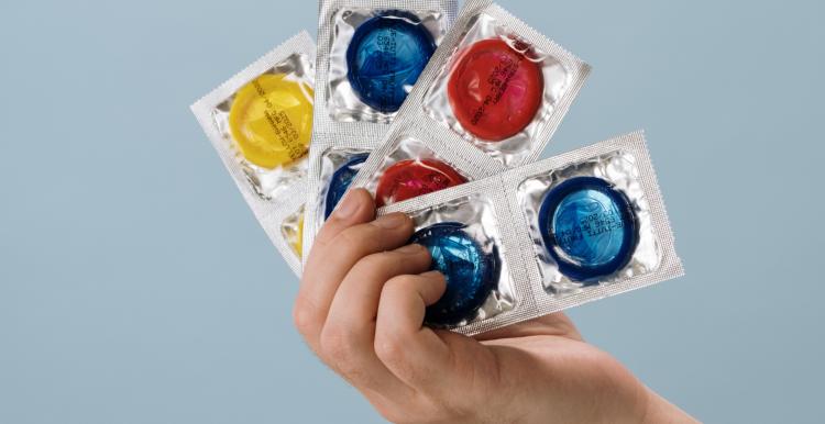 Hand holding condoms