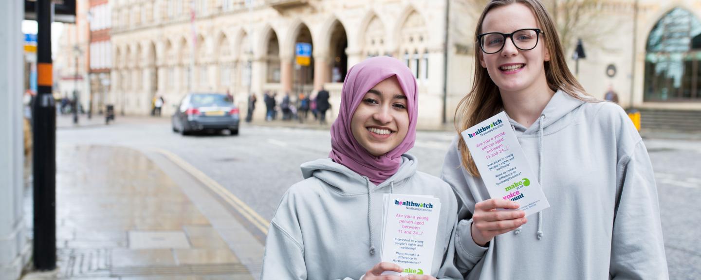 Two young female volunteers promoting Healthwatch