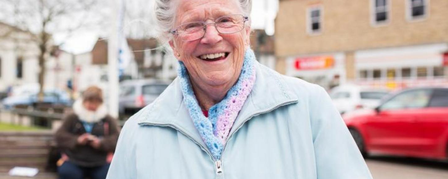 Elderly woman smiling face on to the camera