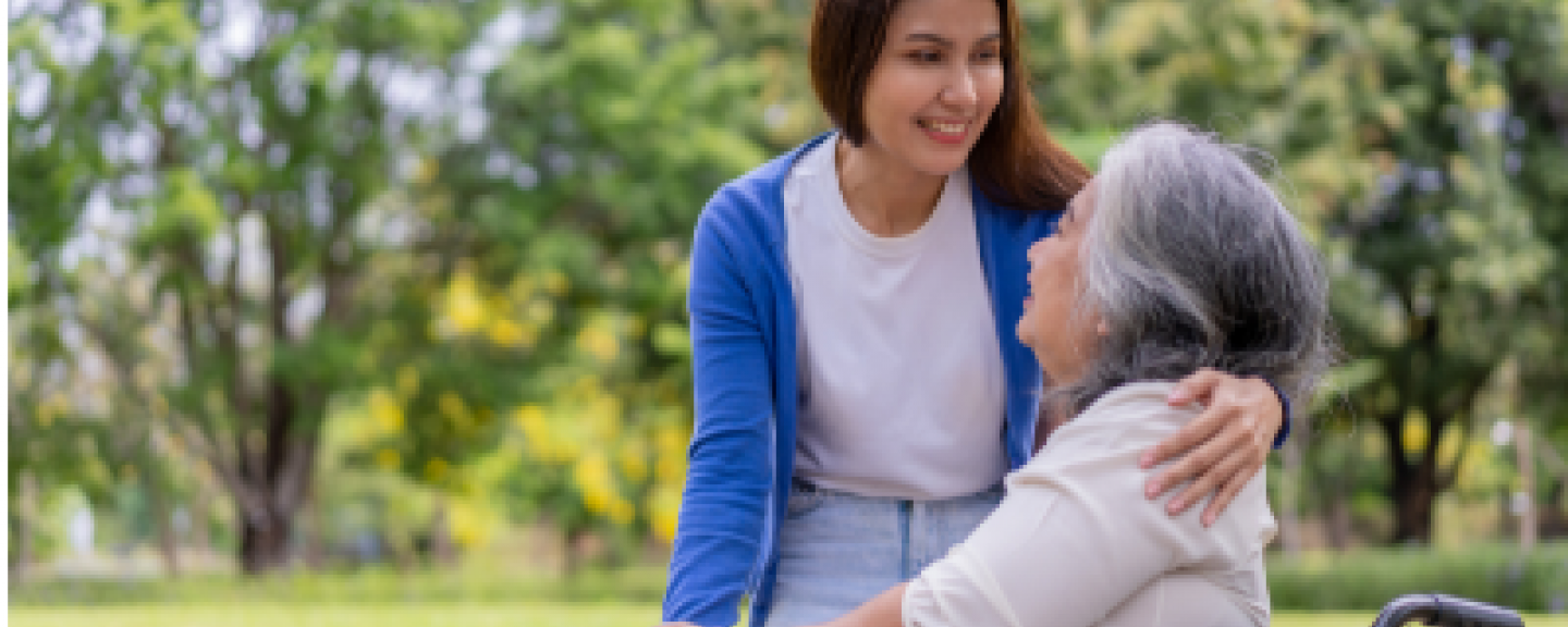 Woman hugging a woman in a wheelchair