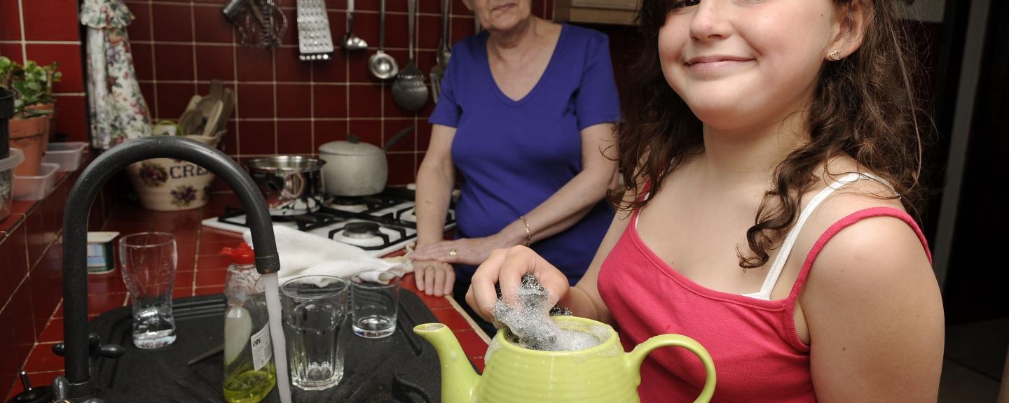A young female carer helping her mum in the kitchen