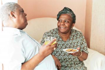 elderly man and woman having a cup of tea