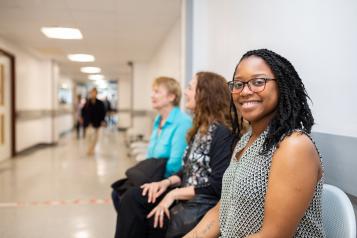 Woman smiling inside hospital waiting room 