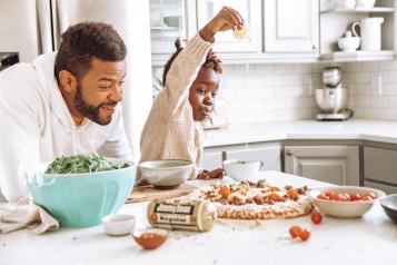 Dad with son playing in kitchen