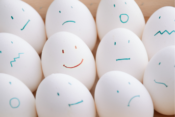 eggs with different expressions drawn up lined up 