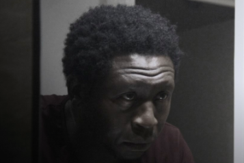 Poster of Orchid film - Black man looking in the mirror