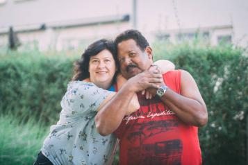 women and latino man couple hugging 