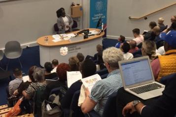Nathan at the front of room, opening the event