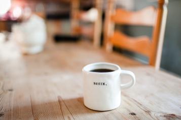 Cup of black coffee on wooden table