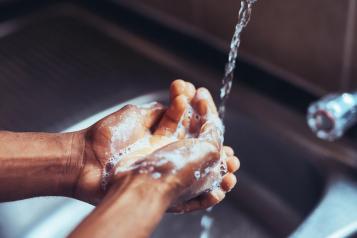 Washing hands under a tap (Getty Images)