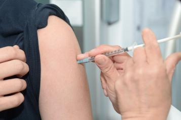 Close up of an arm getting an injection