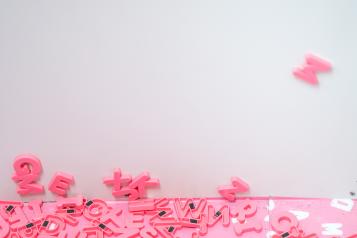 pink letter magnets cascading off wall