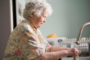 older person washing hands