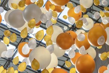 white and yellow balloons in the sky