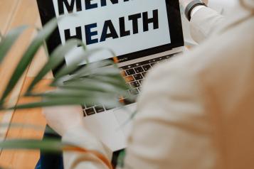 Laptop with the words 'Mental Health' on the screen