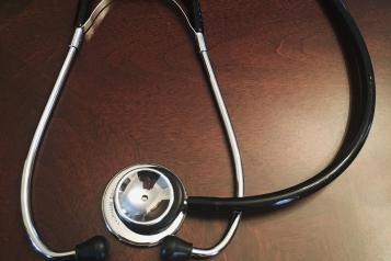 stethoscope on wooden table
