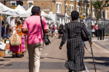 The back of two ladies walking in east street market