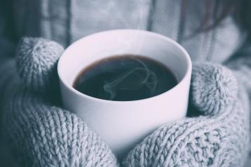 gloves clasping  hot drink