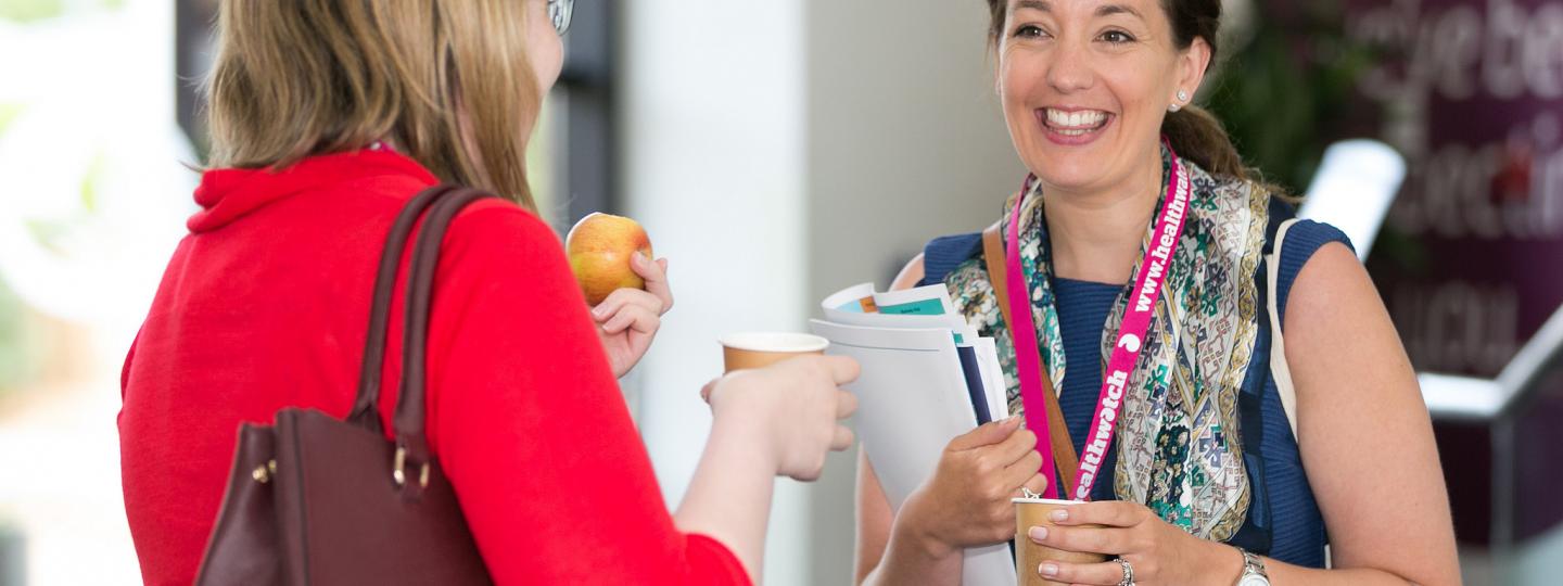 Healthwatch staff members talking to one another