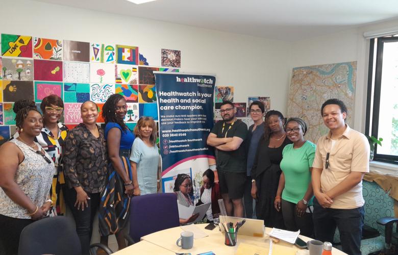 smiling group of people standing in front of Healthwatch banner