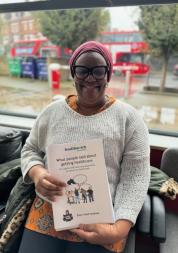 A picture of a woman holding a report.